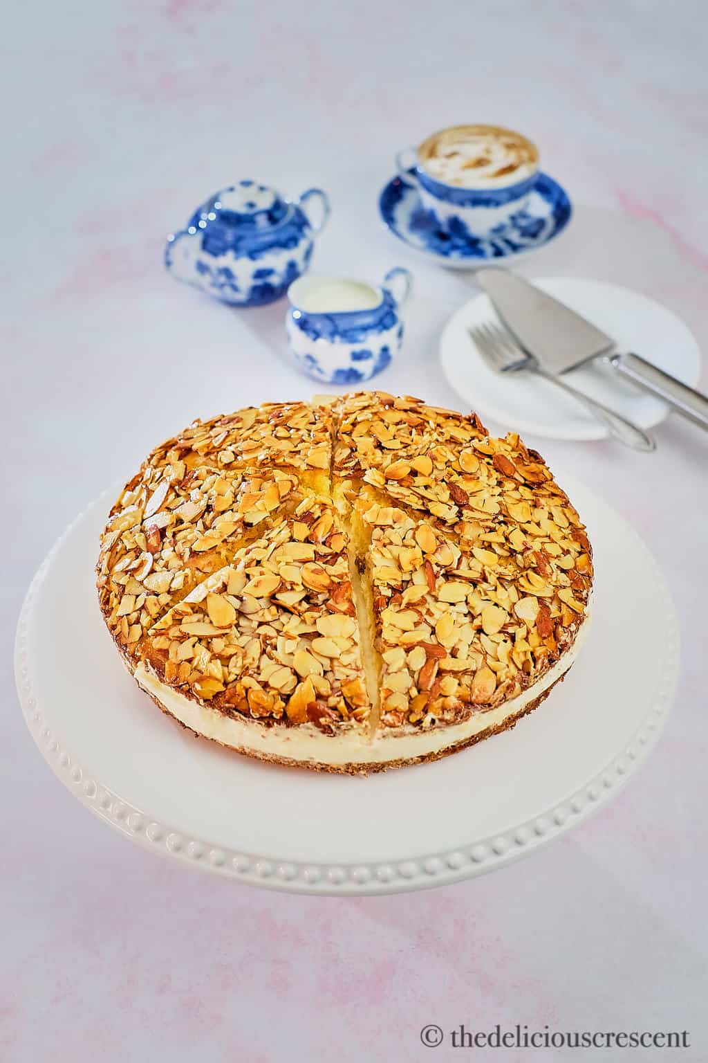 A classic German cake filled with custard and topped with caramelized honey almonds served on the table.