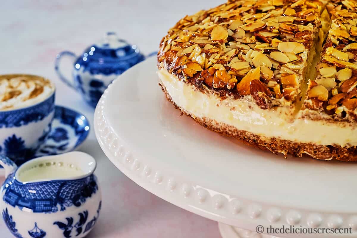 Side view of Bienenstich kuchen on a cake stand.