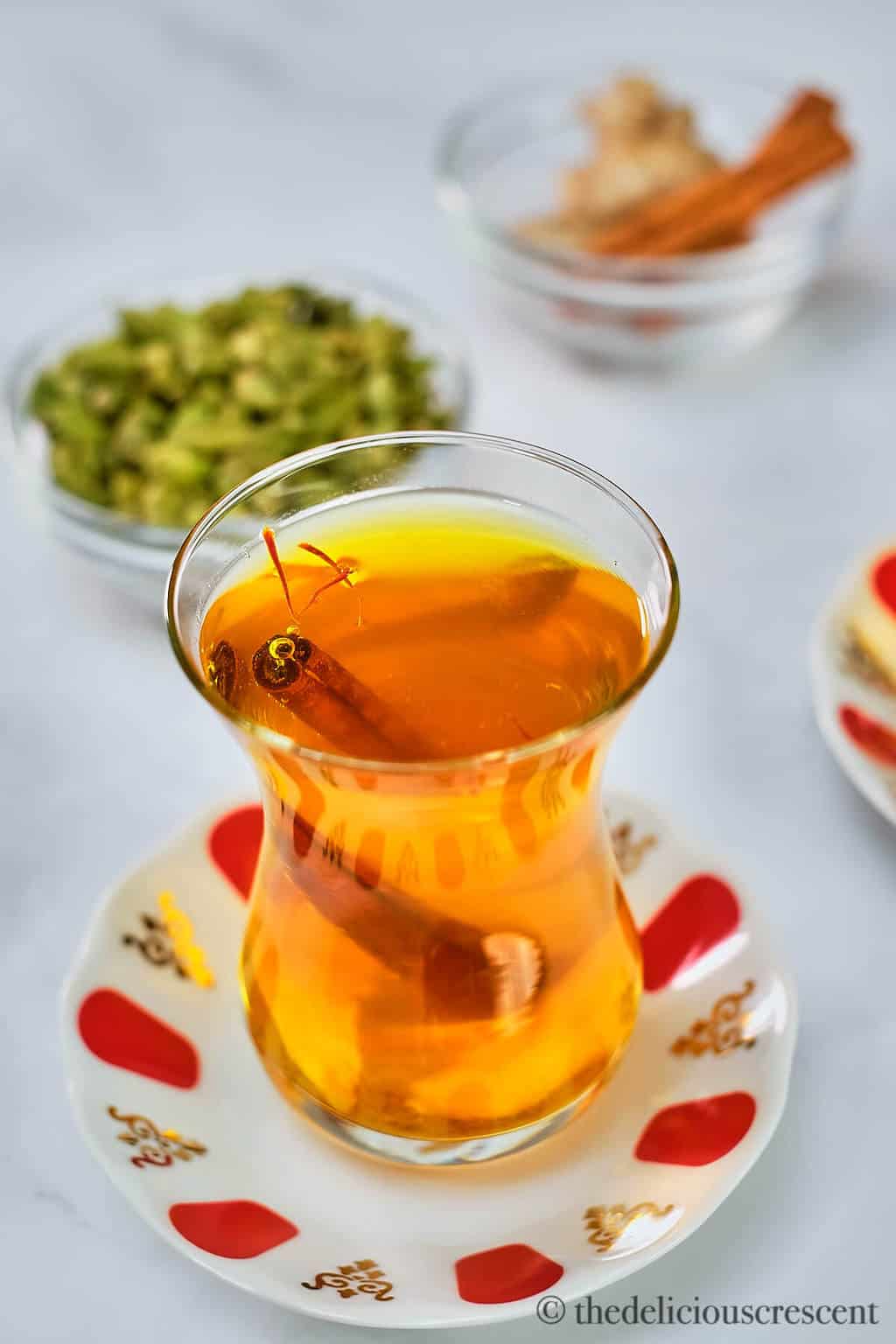 Tea served in a glass cup and placed on a table.