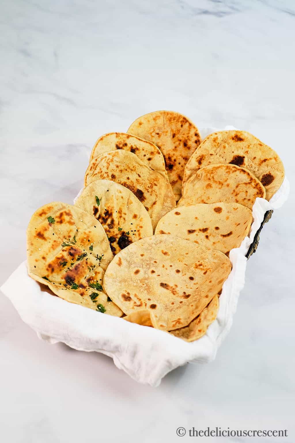 Several breads placed in a basket.