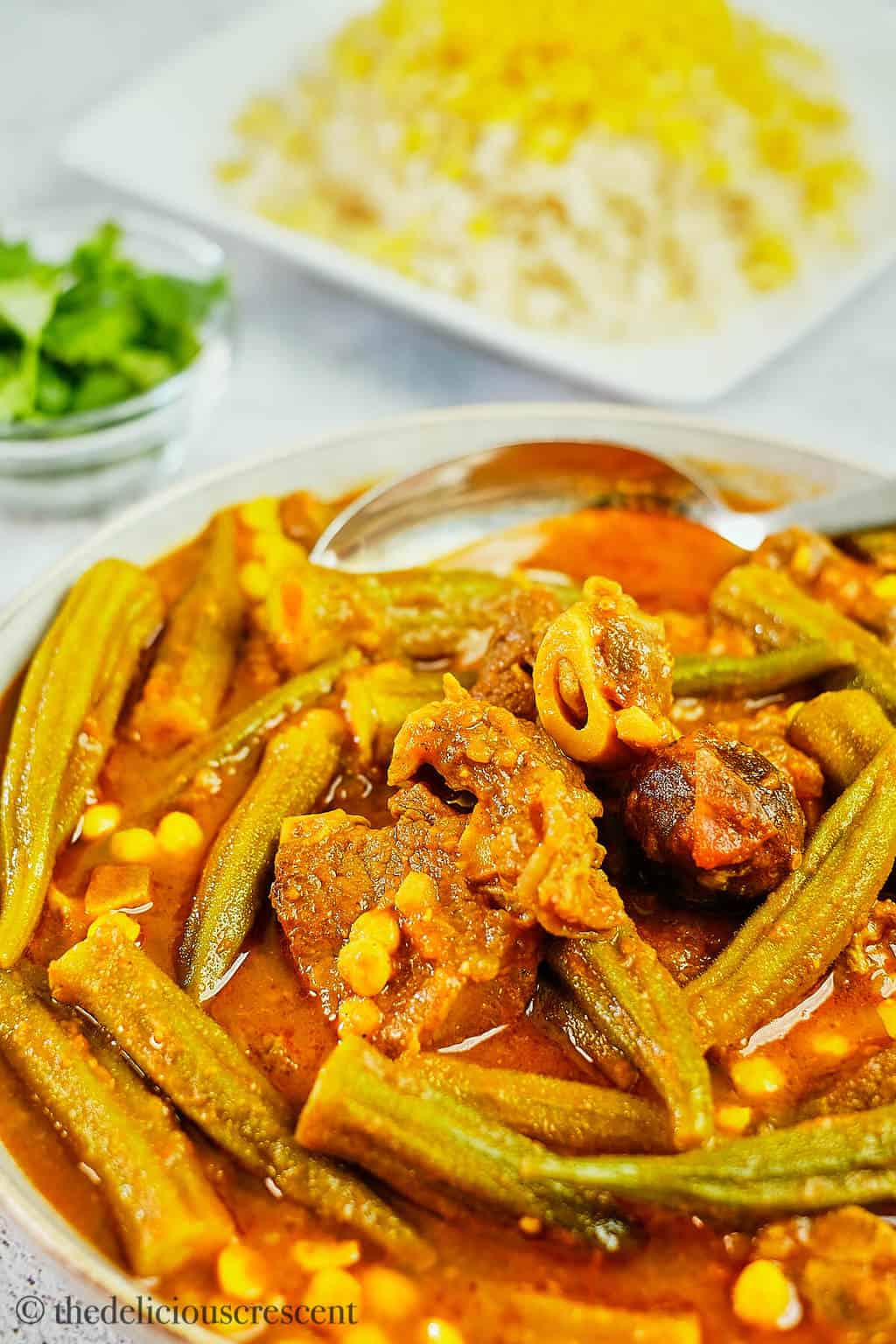 Close up view of Bamya stew in a serving bowl.