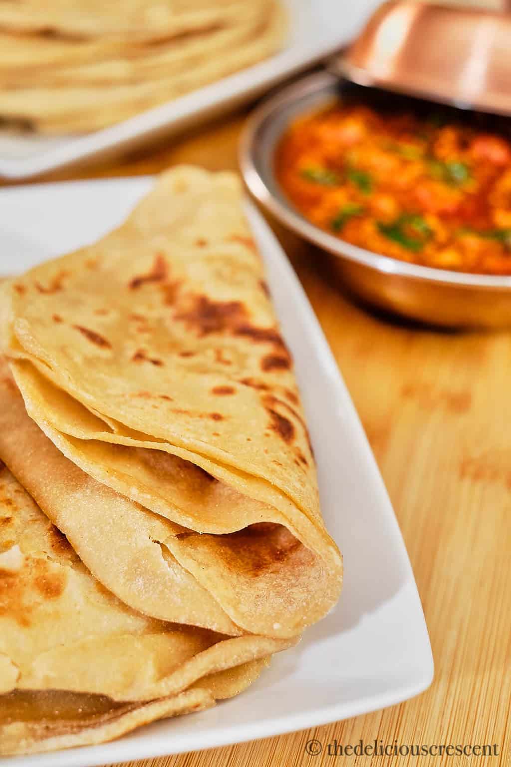 Folded paratha placed on a plate.