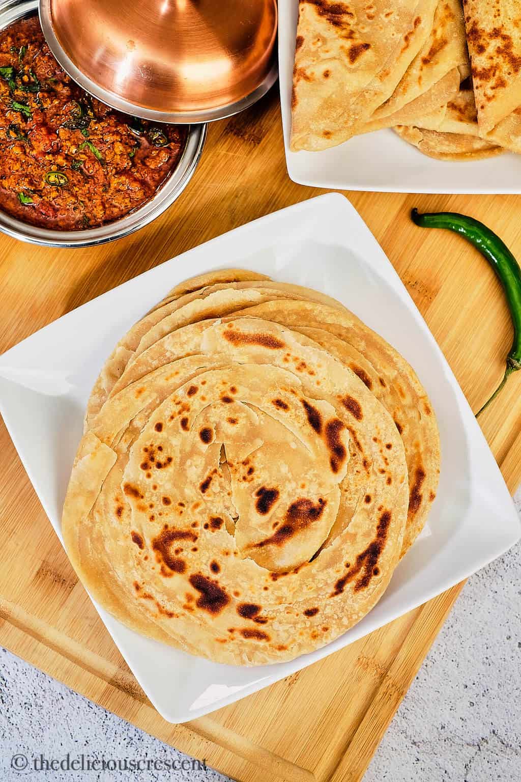 Round layered Indian breads served on the table.