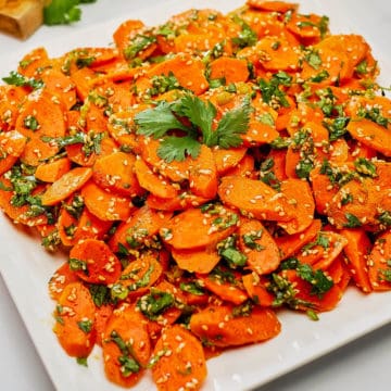 Moroccan carrot salad served in a white plate.