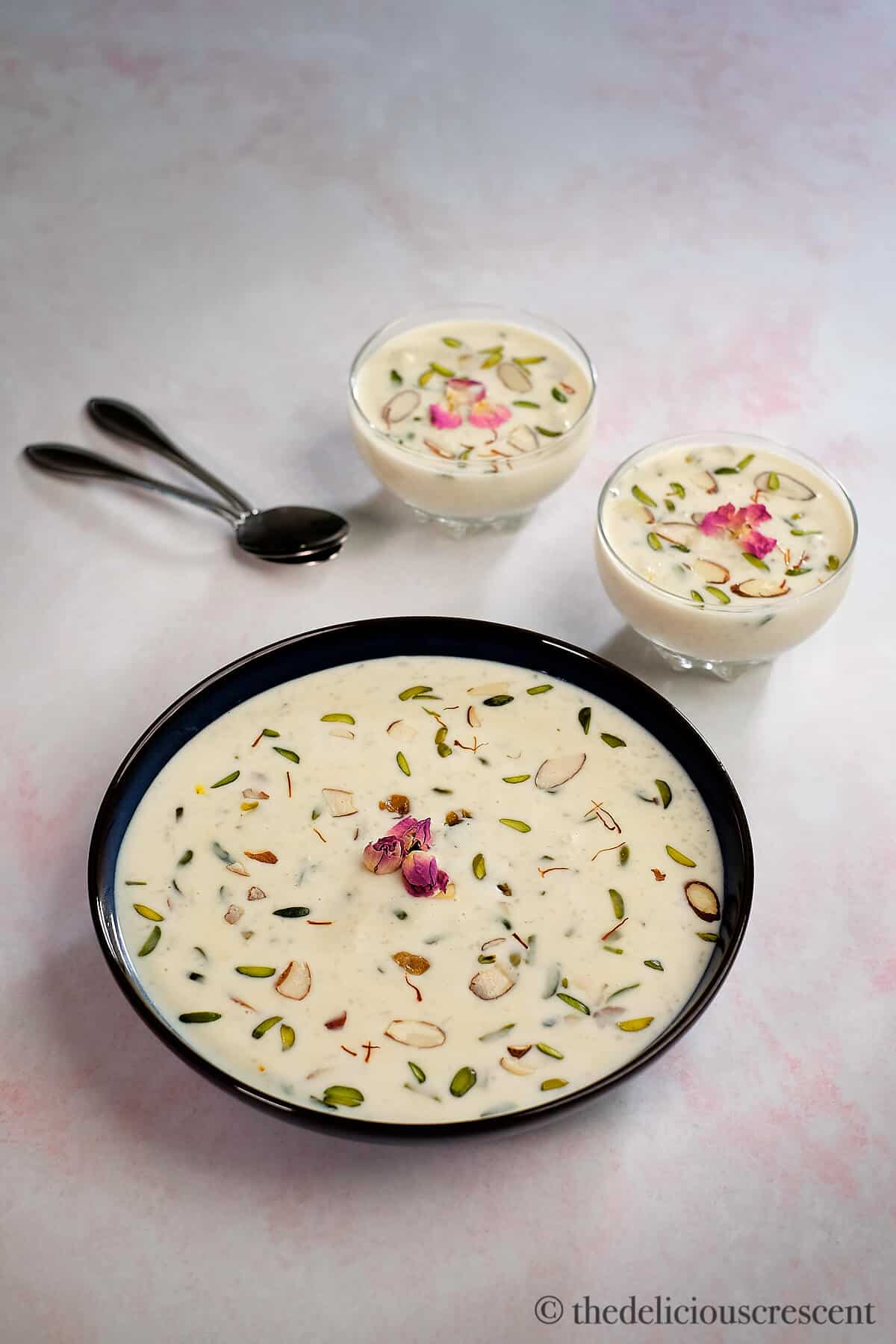 Indian rice pudding in a dark colored bowl.