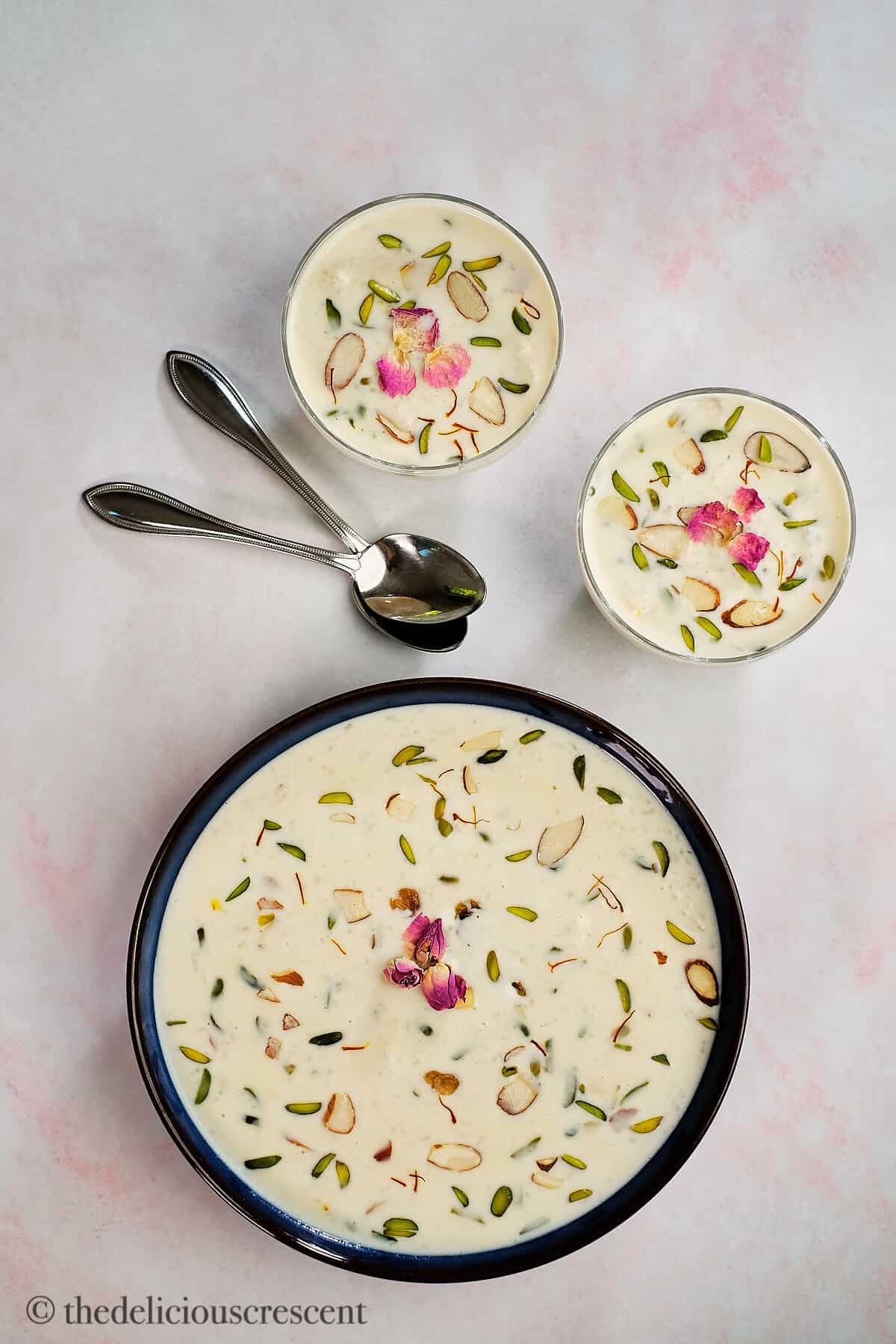 Rice pudding in a large serving bowl and two small bowls.