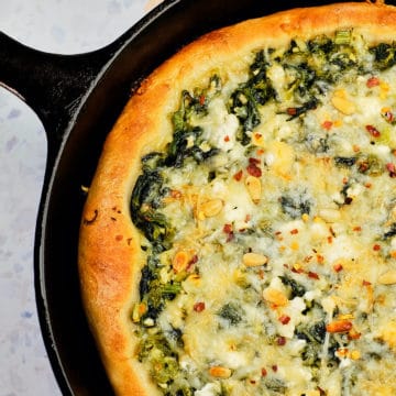 Spinach and feta cheese pizza made in cast iron skillet.