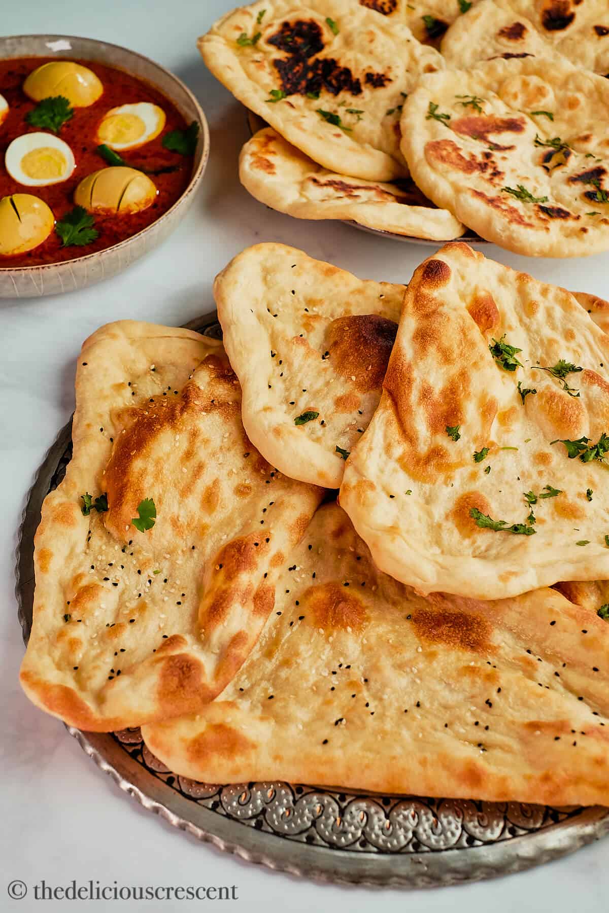 Naan arranged on a metal platter.