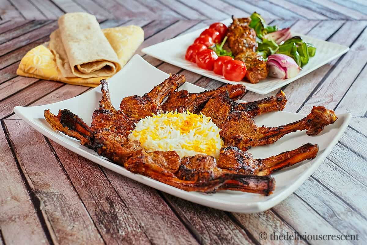 Lamb ribs with rice and grilled vegetables.