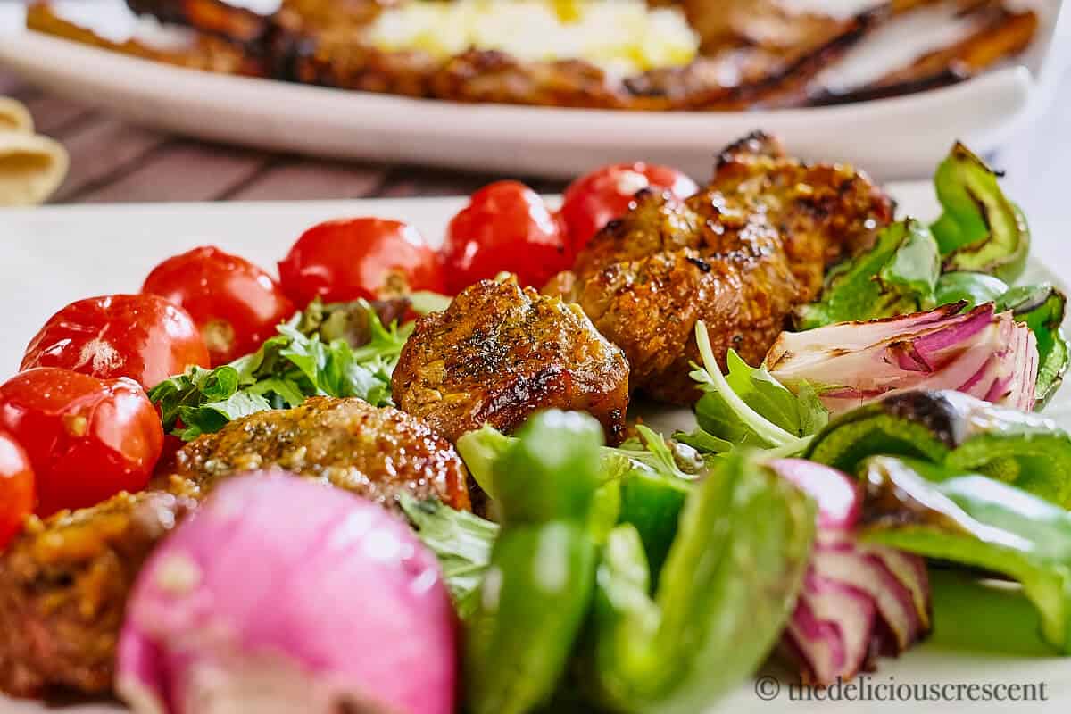 Grilled meat with grilled vegetables on a plate.