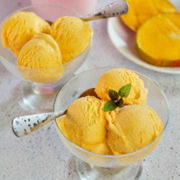 Scoops of mango gelato in glass bowls.