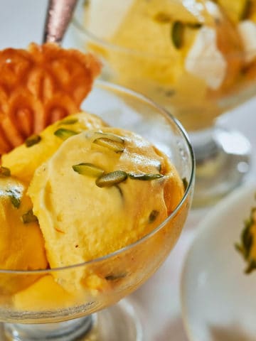 Saffron and rose water ice cream topped with pistachios.