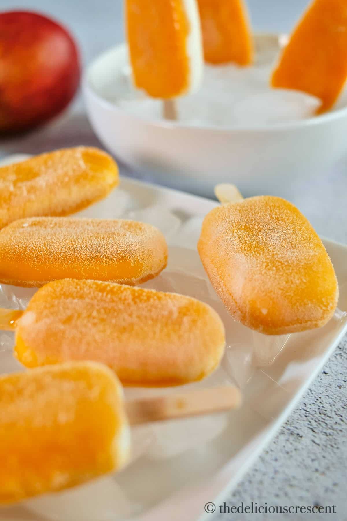 Close up view of mango pops placed on ice.
