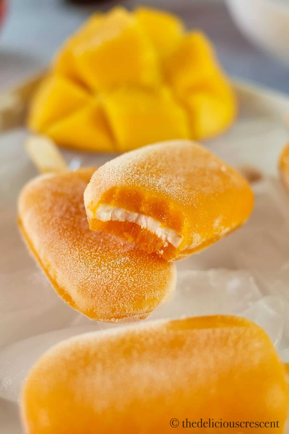 Three layers of a delicious mango dessert pop.