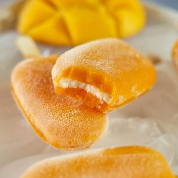 Three layers of a delicious mango dessert pop.