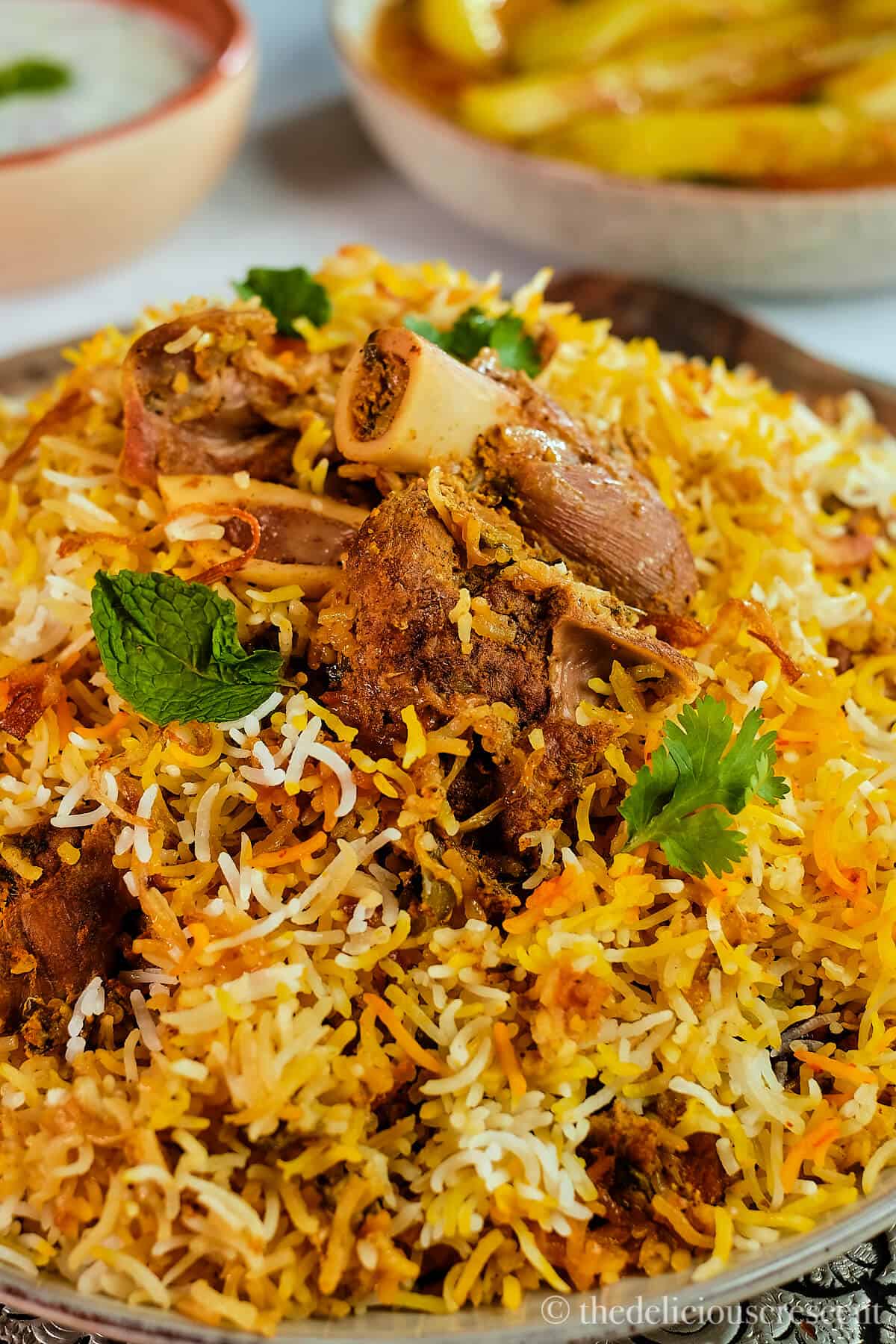 Chunks of marinated lamb on top of a mound of spiced Indian rice.