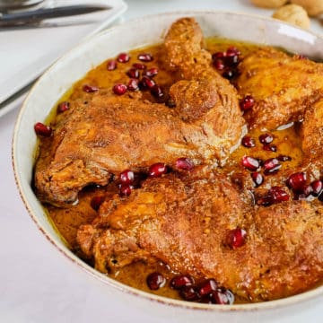 Close up view of Fesenjan served in a bowl with saffron rice on the side.