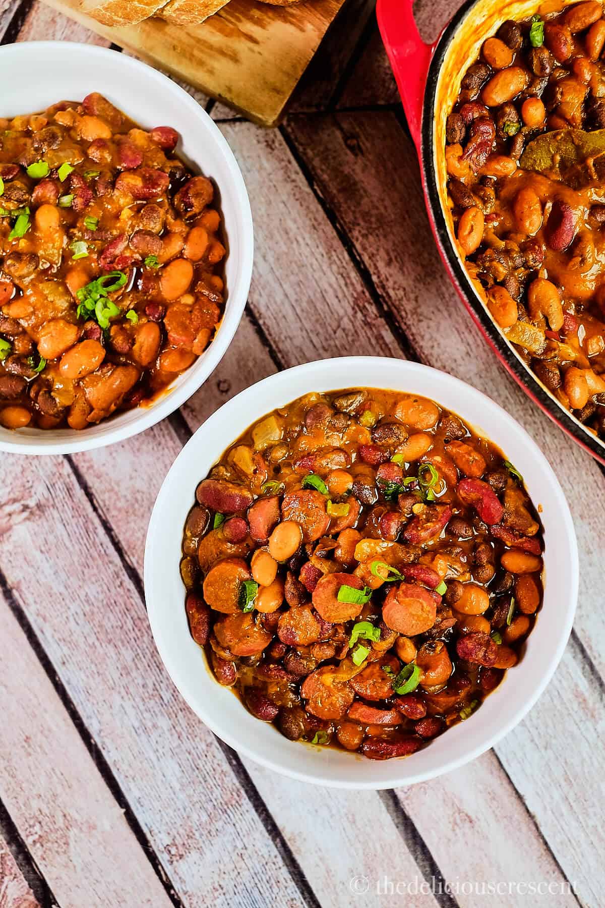 Bowls full of sausage stew with beans.