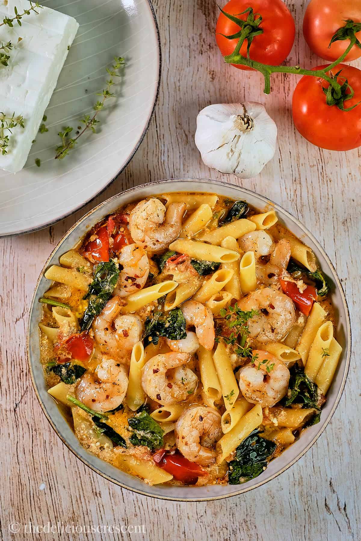Feta cheese pasta served with shrimp on top.