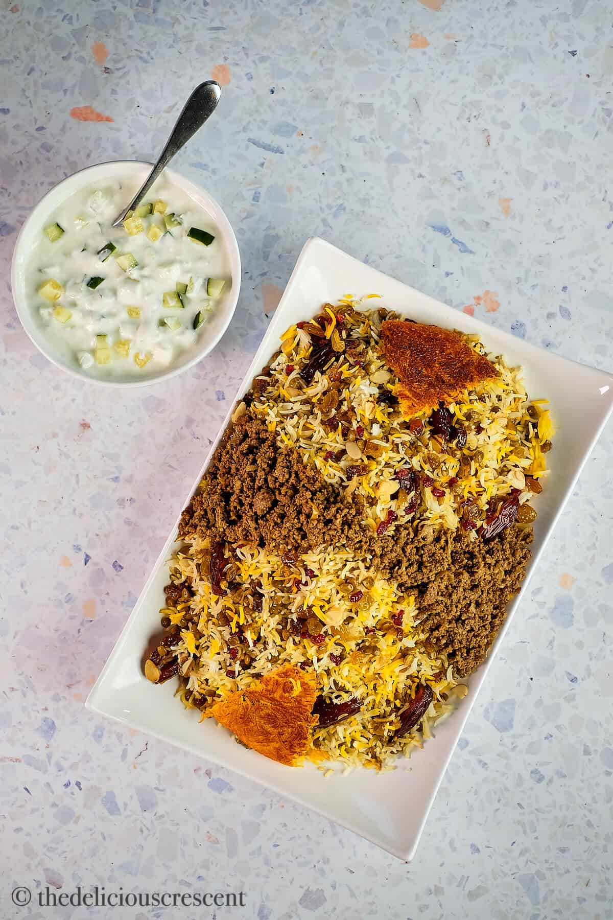 Lentil rice served in a plate along with cucumber salad.