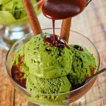 Close up view of green tea ice cream with chocolate sauce.