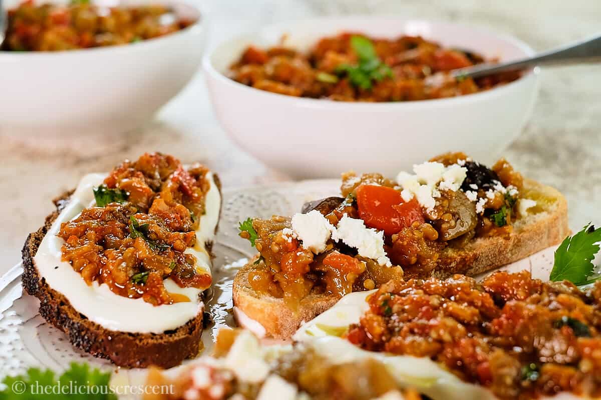 Eggplant salad served on toasted slices of bread.