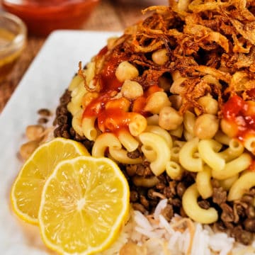 Close up view of Koshari nicely plated and served on a table.