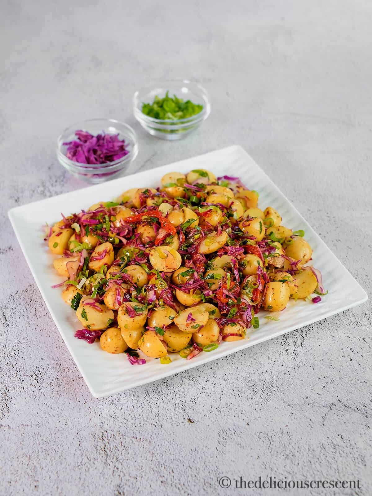 Salad made with baby potatoes, red cabbage, herb and mediterranean style dressing.