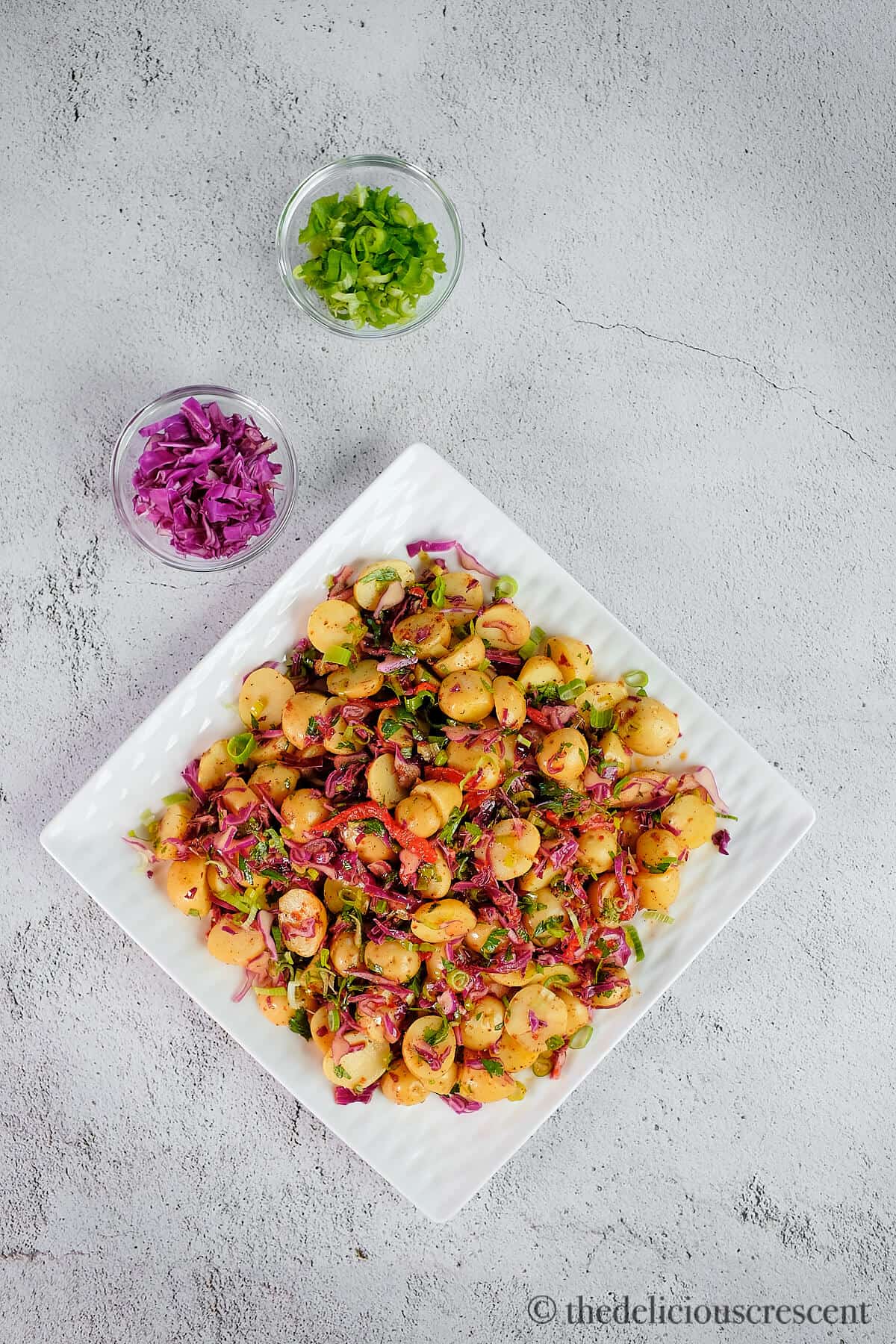 Turkish potato salad served in a white plate and placed on a table.