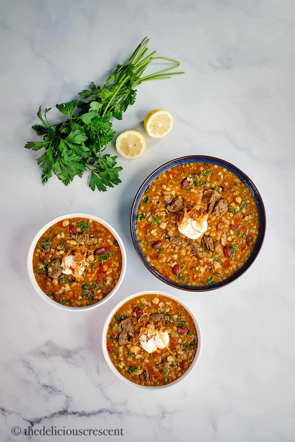 Three bowls full of a hearty Persian style soup.