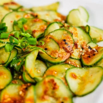 Close up view of pickled cucumber salad prepared in Asian style and served in a plate.