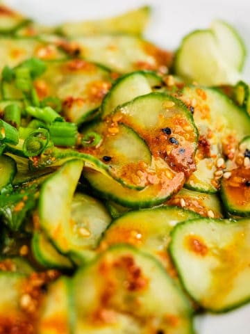 Close up view of pickled cucumber salad prepared in Asian style and served in a plate.