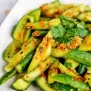 Close up view of pickled cucumber salad prepared in a smashed style with Asian spices.