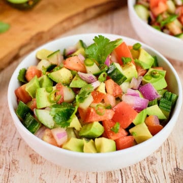 Close up view of Indian kachumber salad in a bowl placed on the table.