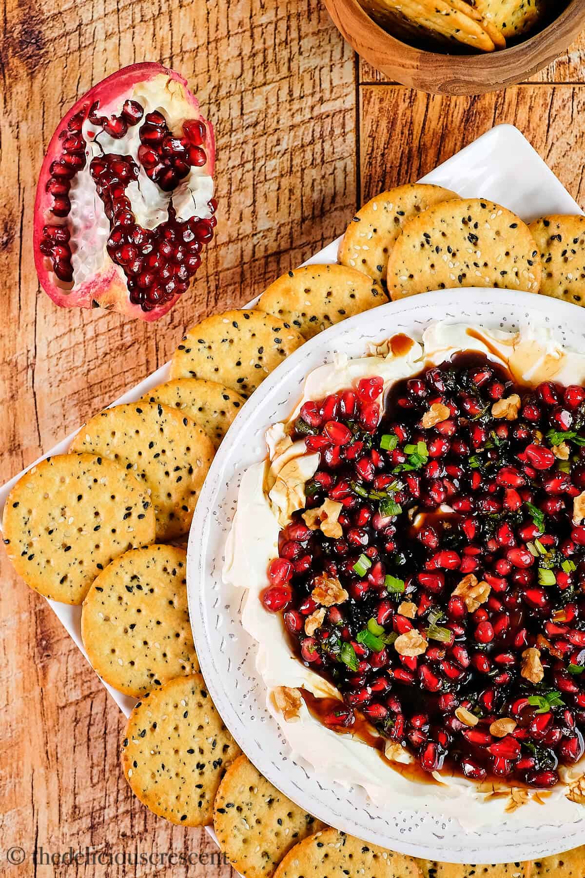 Dip topped with arils, walnuts and served with crackers.