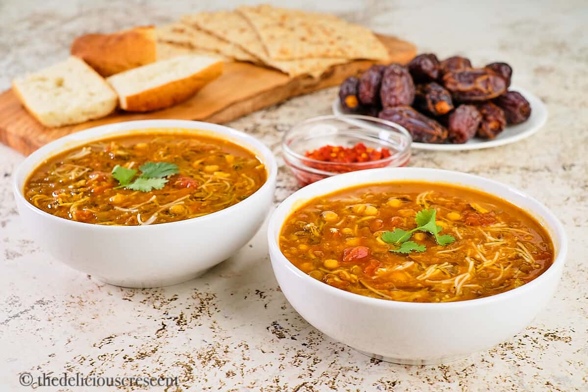 Harira soup served in two white bowls.