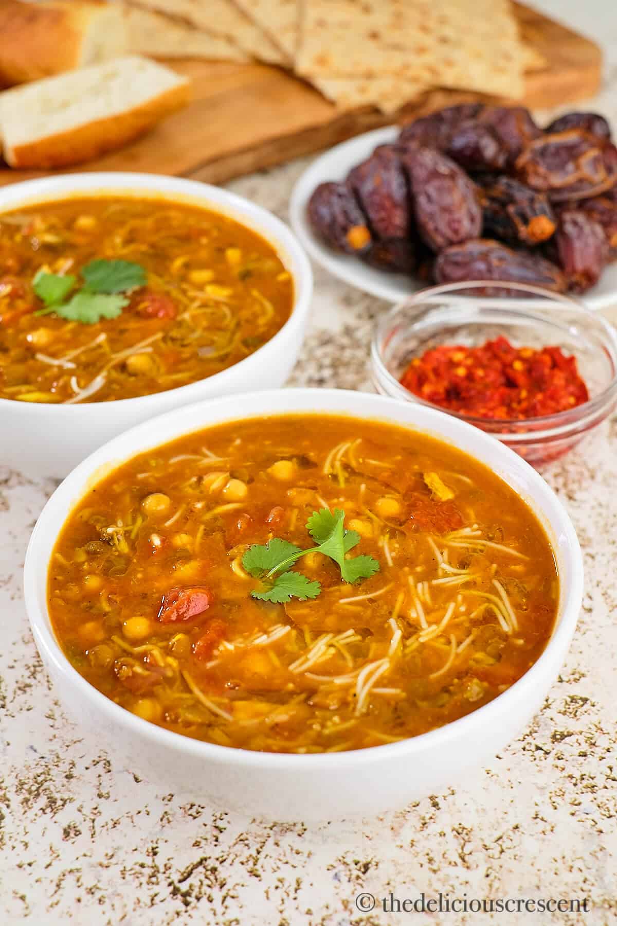 Moroccan harira soup served with dates and bread.