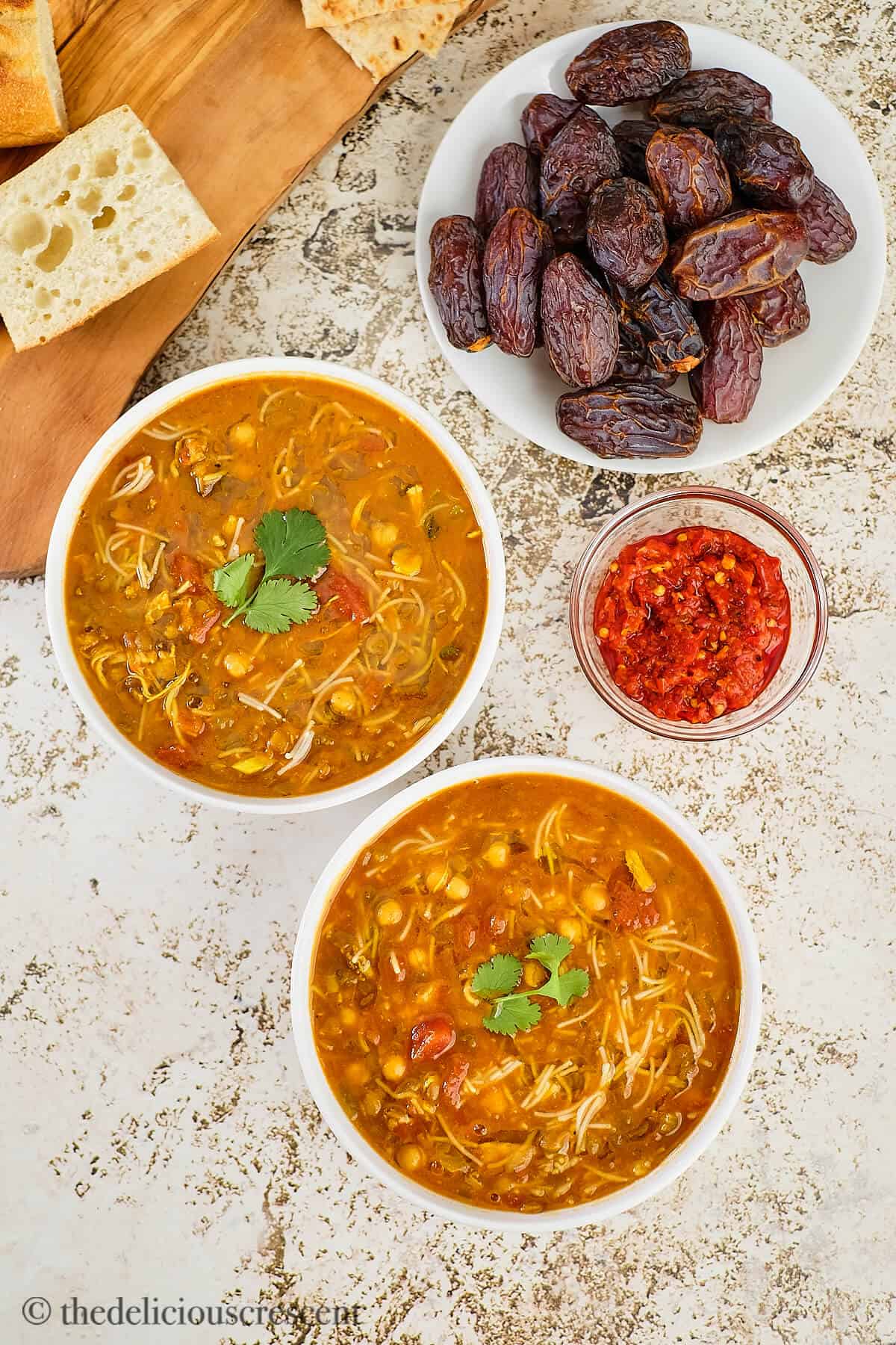 Moroccan chickpea and lentil soup in bowls placed on a table.