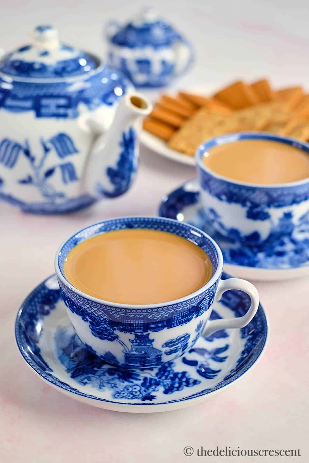 Spiced tea served in elegant blue and white cups.