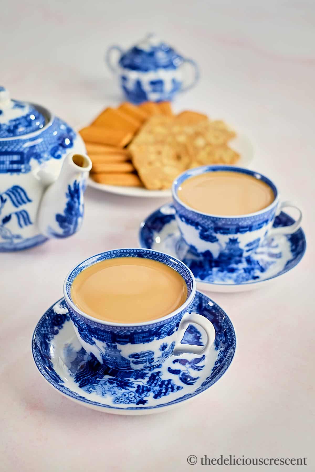 Masala tea served with cookies.