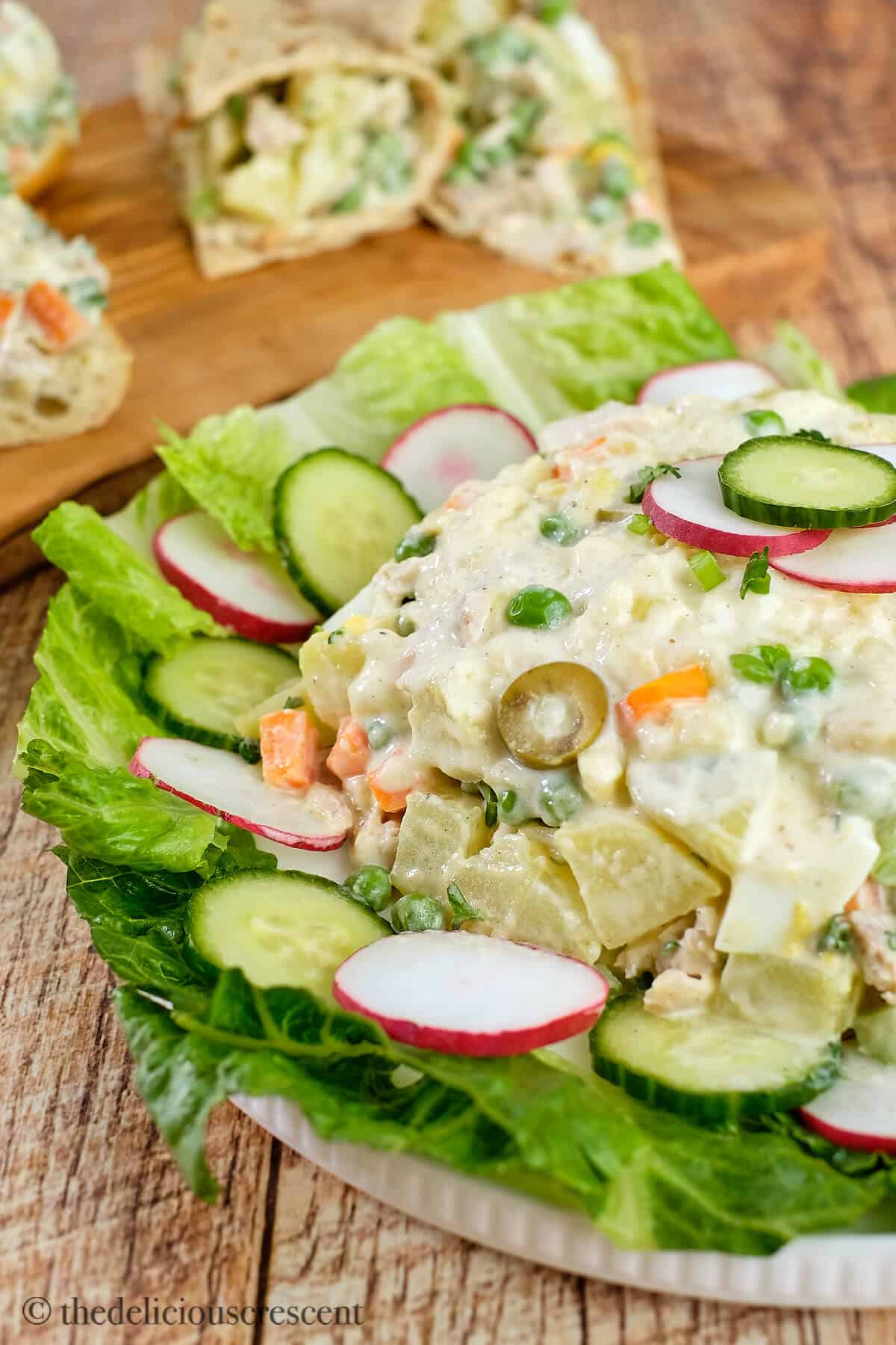 Salad olivieh made with chicken and potatoes served in a plate.