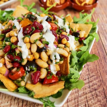 Close view of a plate full of mediterranean bean salad.