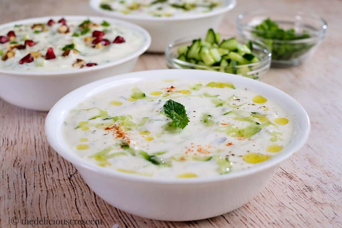 Cucumber raita served in a white bowl.