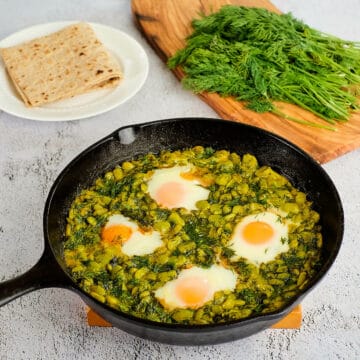 Close view of baghali ghatogh served in a skillet.