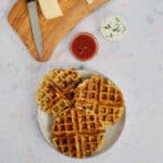 Close view of savory waffles with condiments.