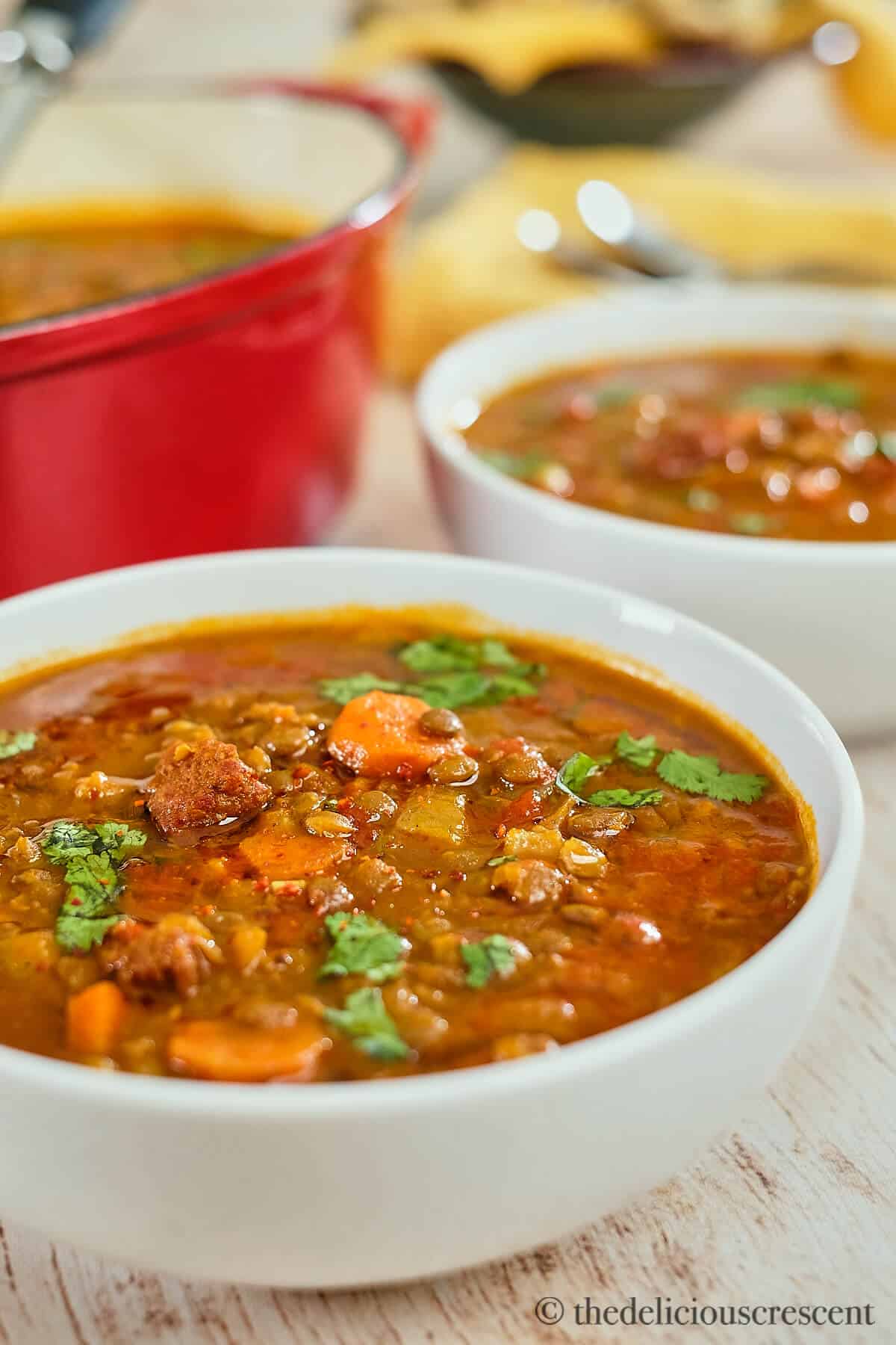 Spicy lentil soup served in bowls.