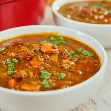 Close up view of spicy lentil soup served in bowls.