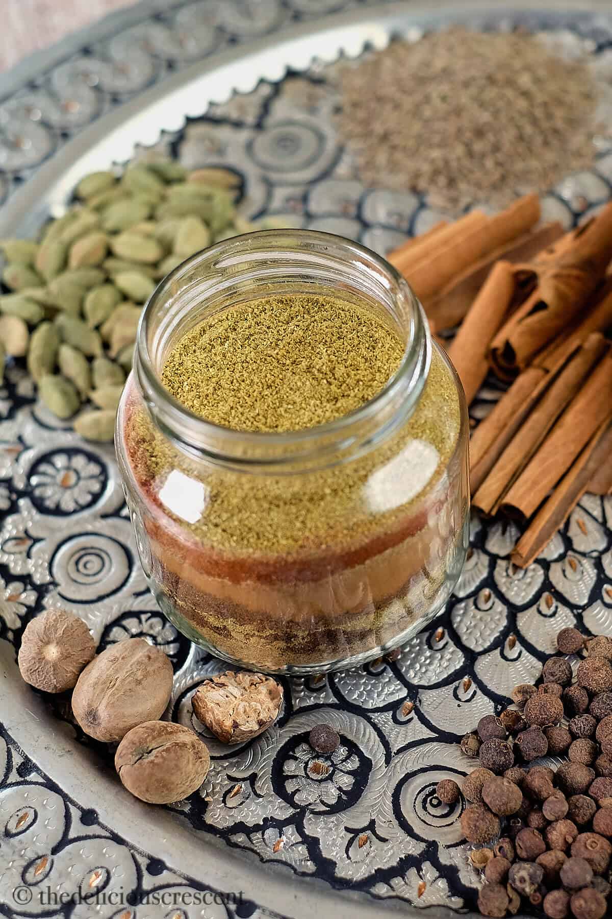 A bottle filled with ground spices.