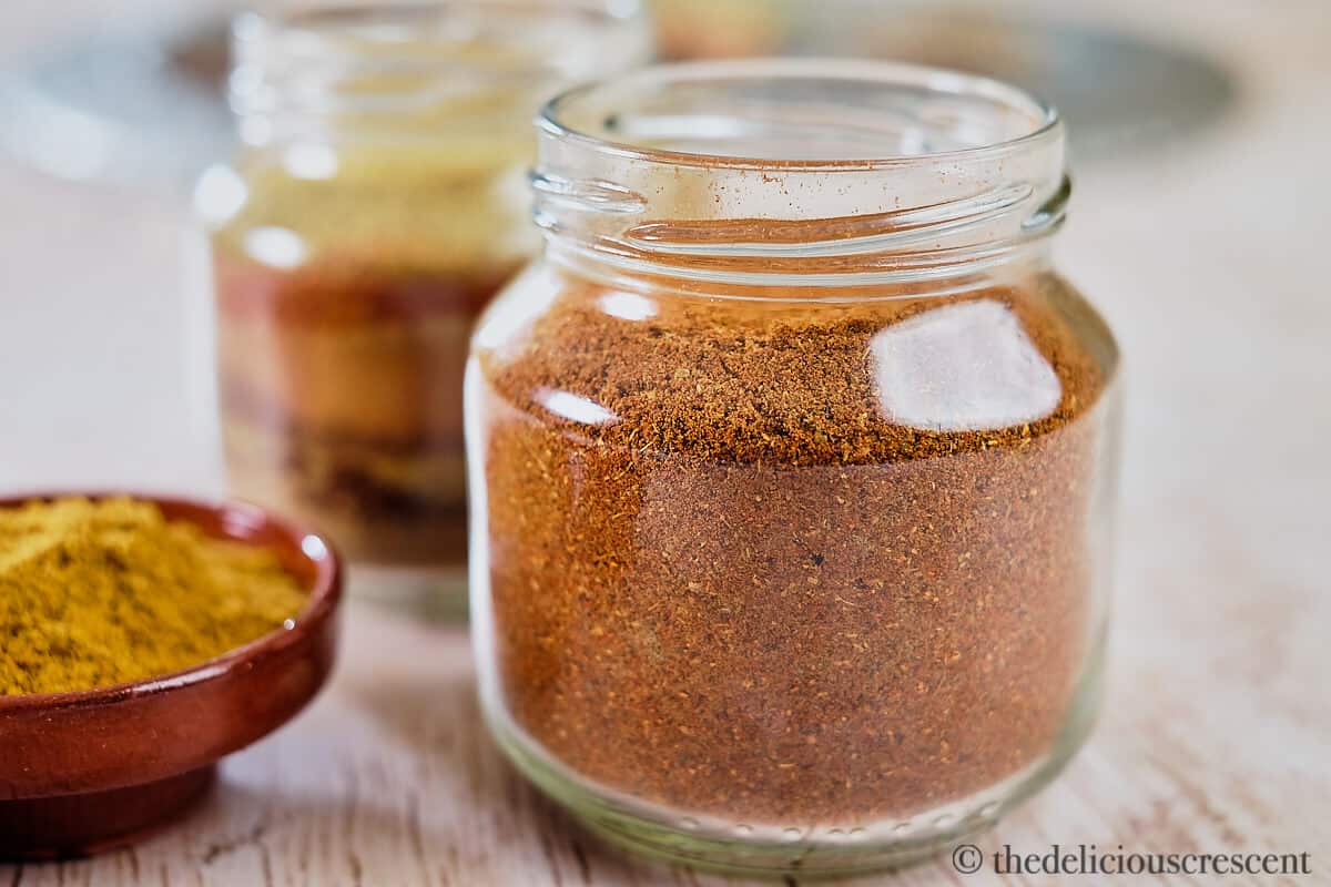 Baharat spice mix in a clear bottle.