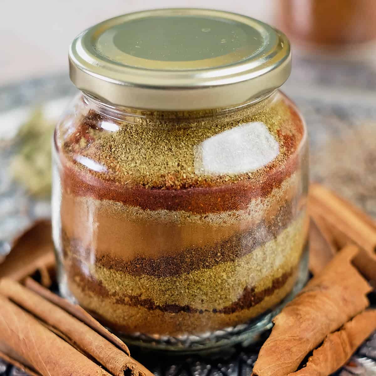 Close view of ground spice layers in a bottle.